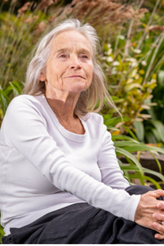 Mature older woman enjoying beautiful outdoor space